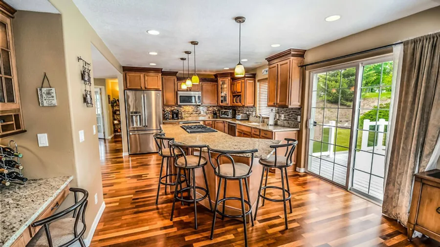 Traditional wood kitchen with a granite island in a newly built home