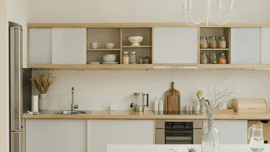 Light wood and white kitchen with open shelving after a full remodel