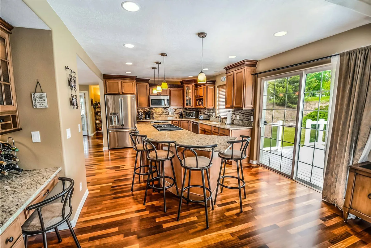 Traditional wood kitchen with a granite island and bar stools